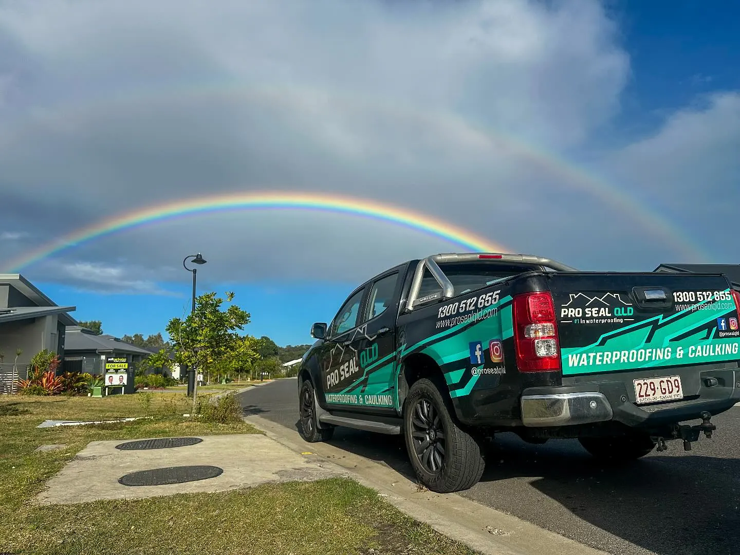 A Pro Seal ute under a rainbow on a Queensland street
